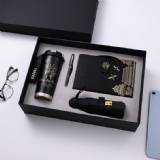 Notebook with pen coffee mug and umbrella